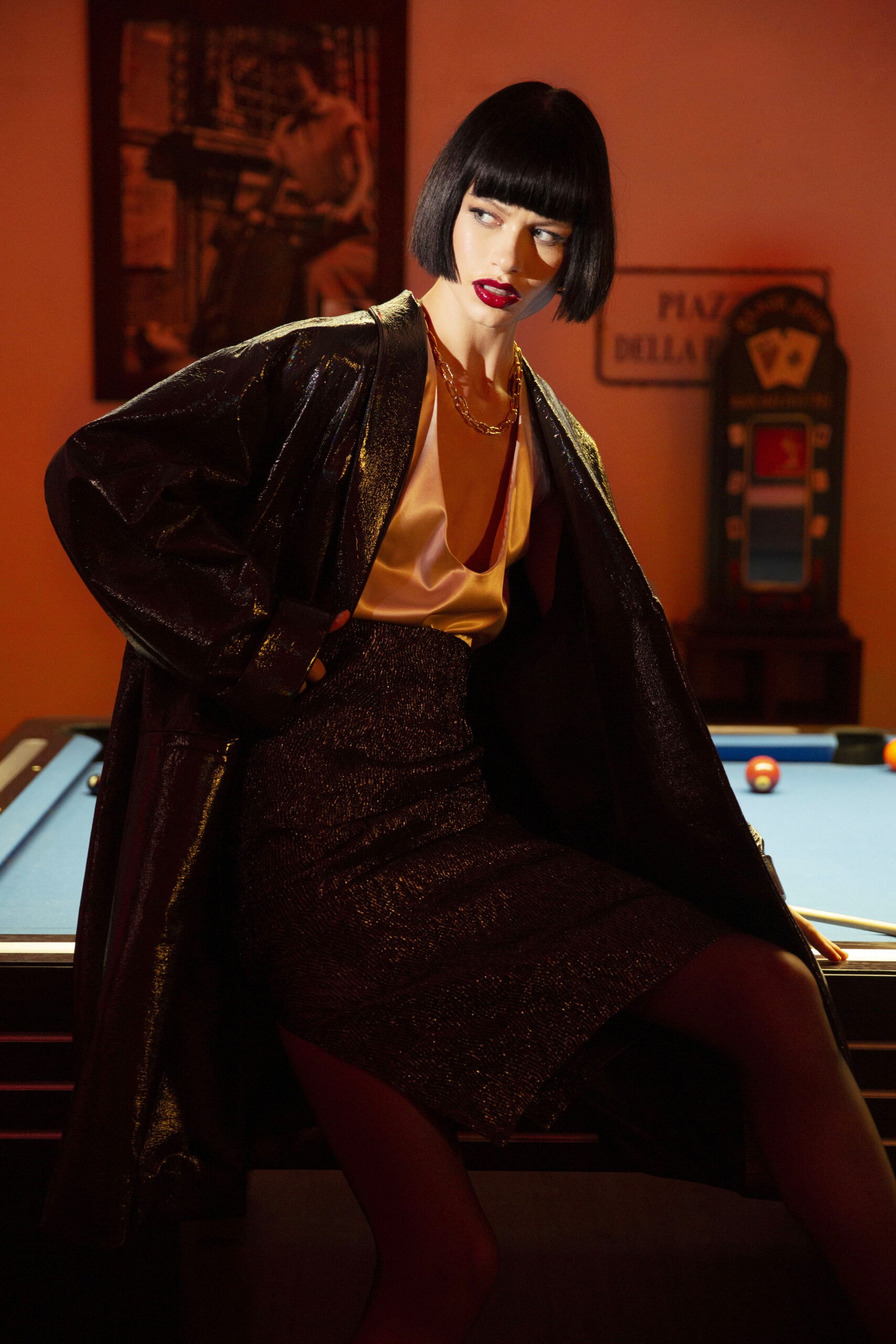 women sitted on a billiard 's table