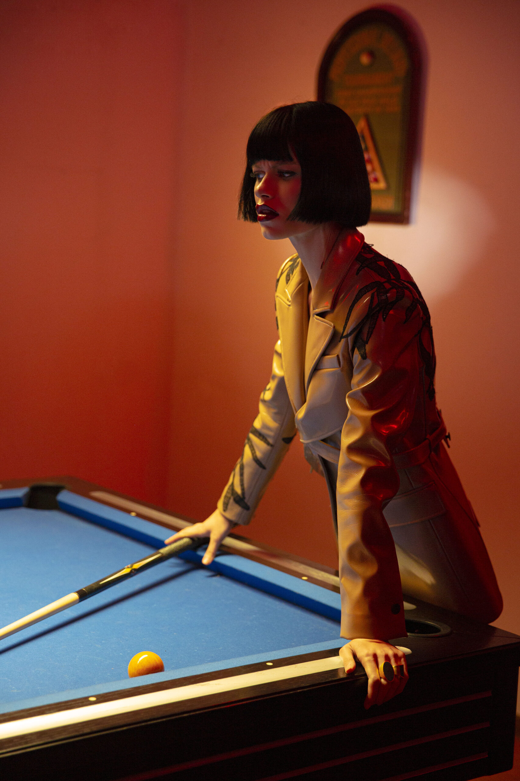 WOMEN LOOKING OVER A BILLIARD TABLE